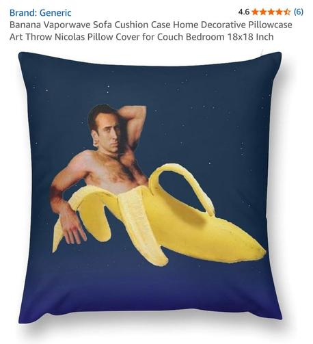 Screenshot of an Amazon page, showing a pillow of a young, nude Nicholas Cage mercifully ensconsed in a banana peel from rib cage on down, against a starry midnight sky