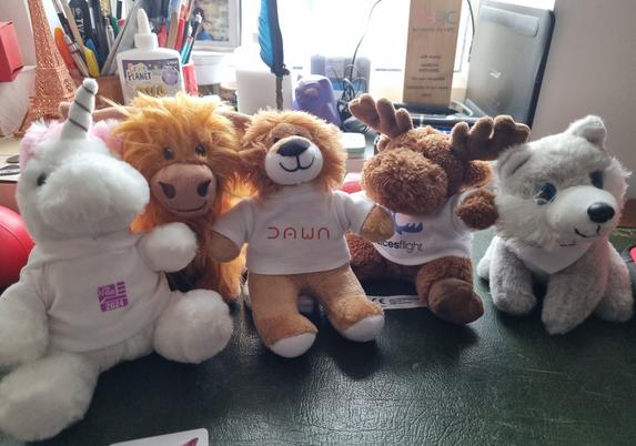 Cuddly toys: The Dawn lion sitting between the US RSE unicorn, the EPCC highland cow, the LUMI wolf, and the Alces Flight moose.