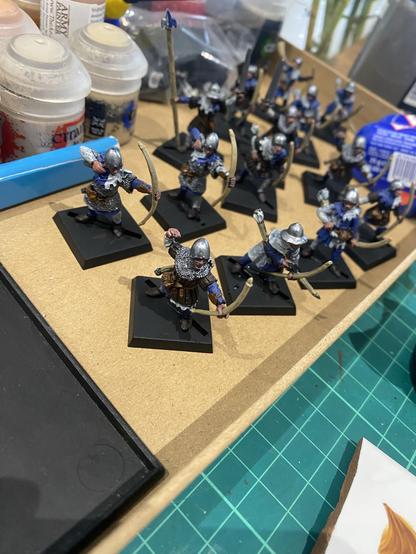 A cardboard tray with a range of Miniature Archers Painted in Blue and White.