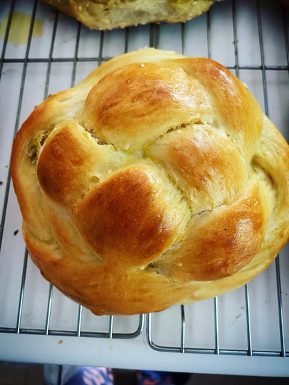 A perfectly-baked round challah with a deep golden brown egg wash but not so brown that you wonder if someone over baked it. Like you know the crust won’t be gross with this.