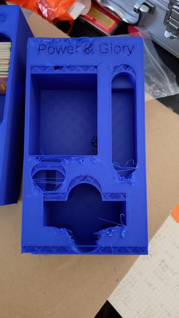 A royal blue print of a board game insert, the final 2 layers of the print are shifted up by approx 4mm and the top is somewhat scruffy&10;