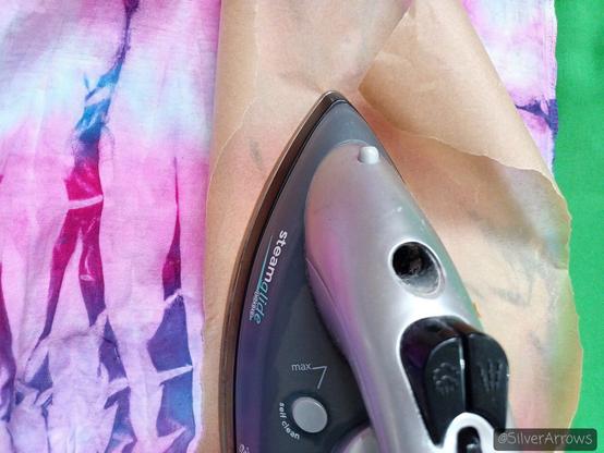 Ironing the tiedye scrap with some greaseproof paper between the iron and the fabric