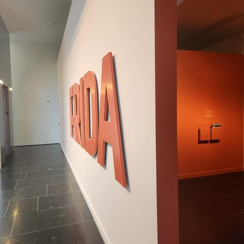 Entrance to Frida Kahlo art exhibit at a museum displaying "FRIDA" in bold letters