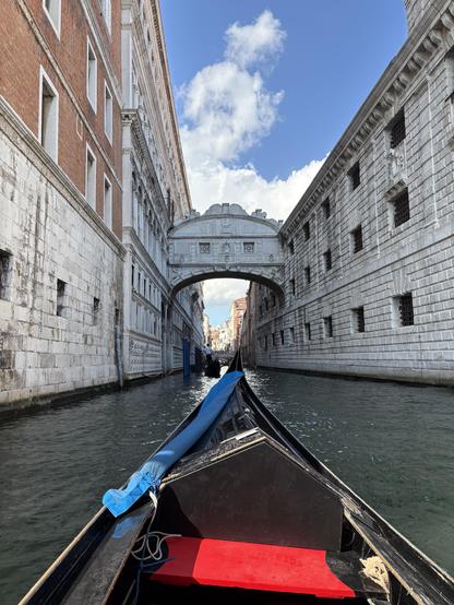 View of Bridge of Sighs in Venice taken from canal on southern side of bridge. Bottom half of photo shows front half of a gondola.