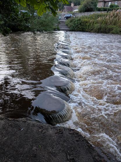 Stepping stones are submerged with a few inches of water pouring over the top.