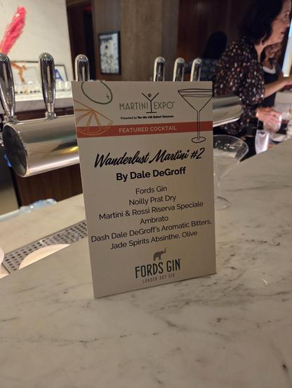 placard with the recipe for Dale DeGroff's Wanderlust Martini #2: Ford's Gin, Noily Prat Dry, Martini & Rossi vermouth, Ambrosio, bitters, absinthe, olive