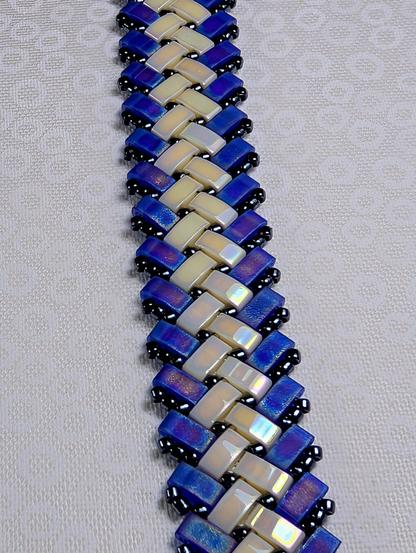 A herringbone half-tila bracelet in matte purple and iridescent cream.