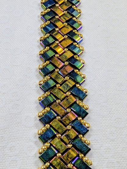 A herringbone half-tila bracelet in metallic green and bronze.