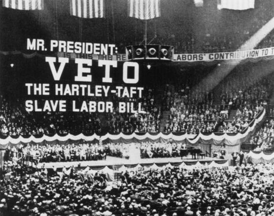 AFL union rally, Madison Square Garden, New York City, 1947, with large sign that reads: Mr. President, Veto the Taft-Hartley slave labor bill.