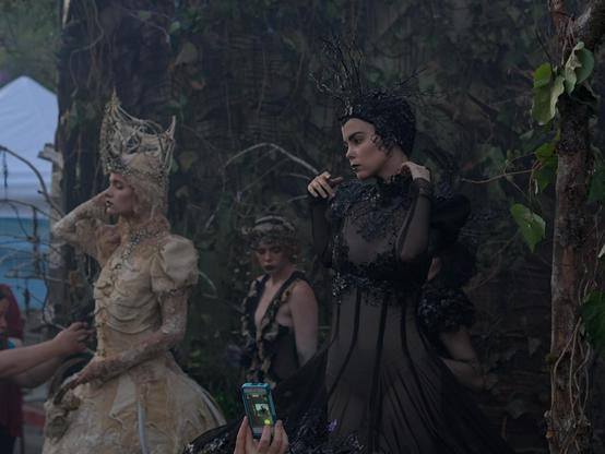 Models posing for an art display in their costumes
