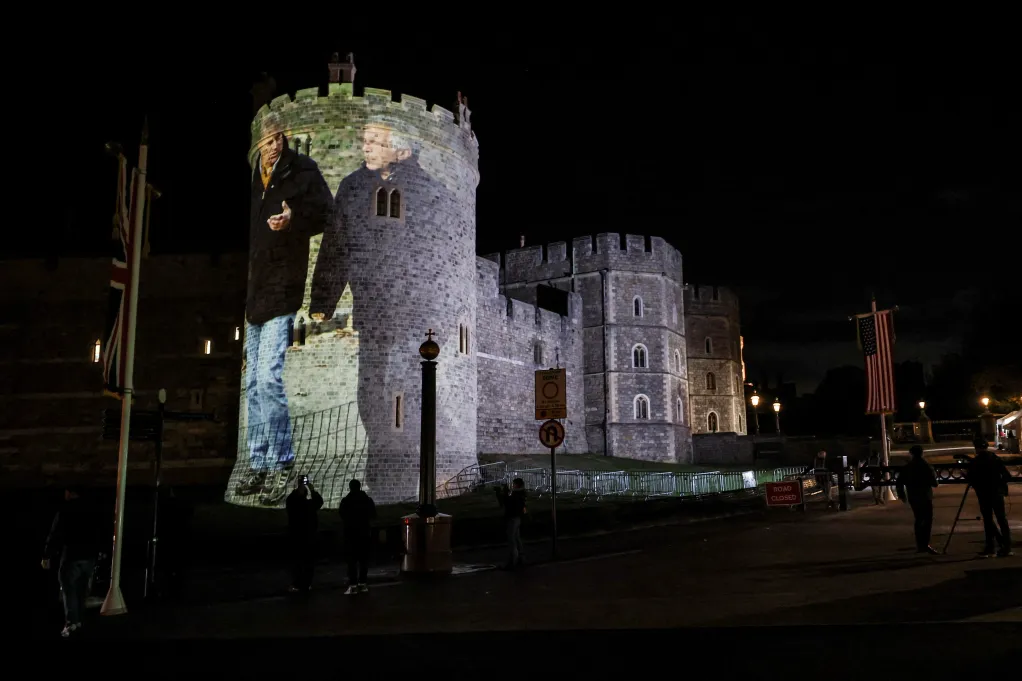 A photograph of P. Andrew and Epstein projected onto the castle
