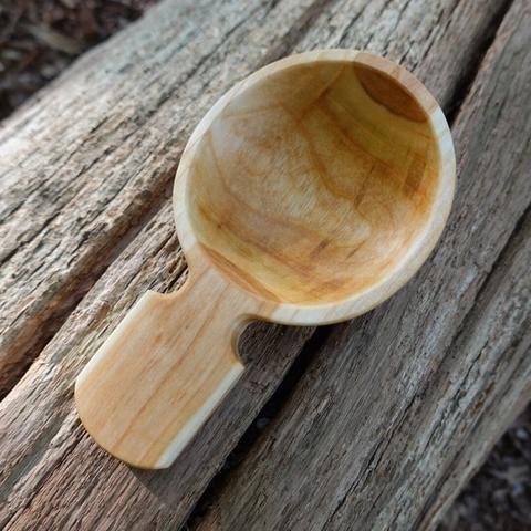 Wooden scoop on an old tree trunk