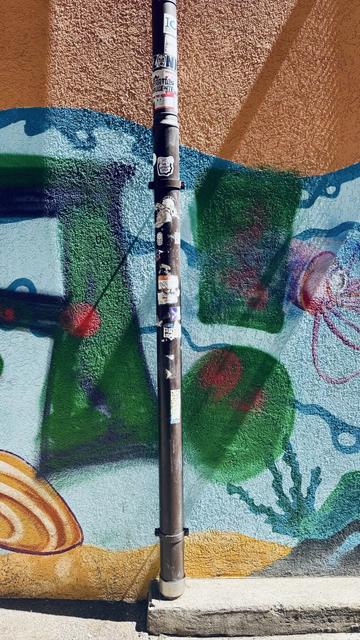 Sticker on an water pipe representing a cartoonish hand linked to foot by a black limb and is ticking the foot with a feather. The text on the sticker says «  The Vicious Cycle » by NoeGrit