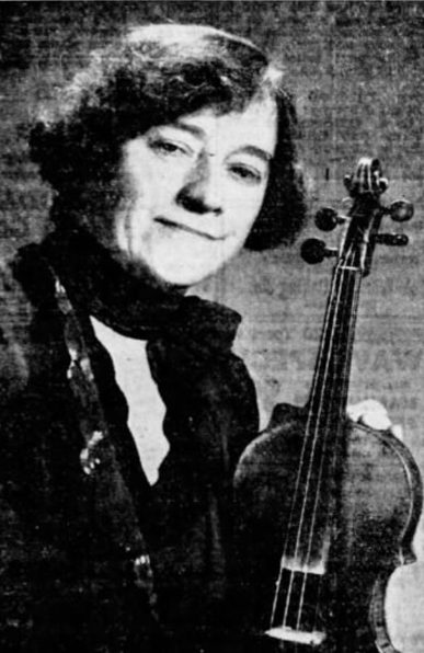Edith Rubel, a smiling white woman with bobbed dark hair, holding a violin
