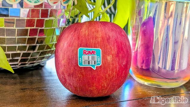 Rave Apple in front of a disco ball and shiny candle.