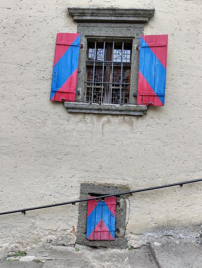 a tiny window below a bigger window at the stone steps at Riegersburg
