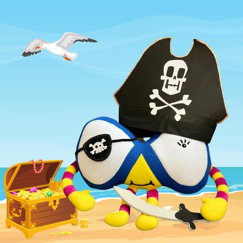 The image shows an illustrated seaside scene with the ocean, sandy beach, a seagull flying in the sky, and an open treasure chest. Superimposed on this scene is a photograph of the Maths Week Scotland Mascot Finn Finity wearing an eyepatch, a pirate hat, and holding a small cutlass.