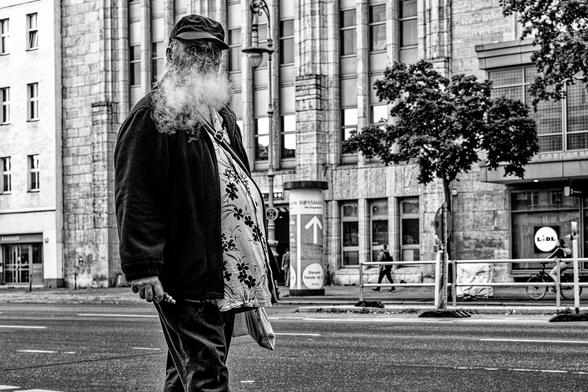 Man with an e-cigarette and smoke that looks like a white beard