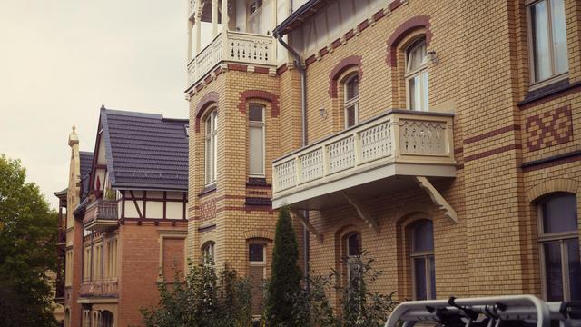 yellow brick building with wooden balconies