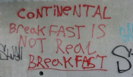 Graffiti which reads “continental breakfast is not real breakfast”