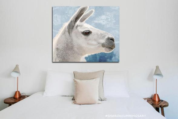 Soft white llama on blue watercolor by artist Sharon Cummings.  Set in a bedroom setting.