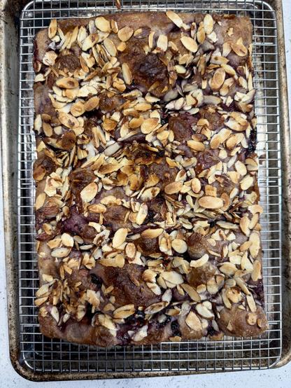 After baking, the bread and almonds are golden brown and the jam has melted into the bread