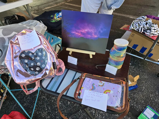 A setup with a little table and four items for sale.