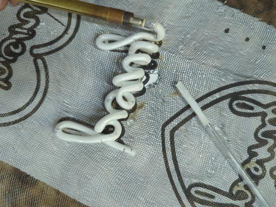 phosphor coated glass pony on the pattern before attaching the last electrode. You can see the tube I was using as a handle cut off right next to it