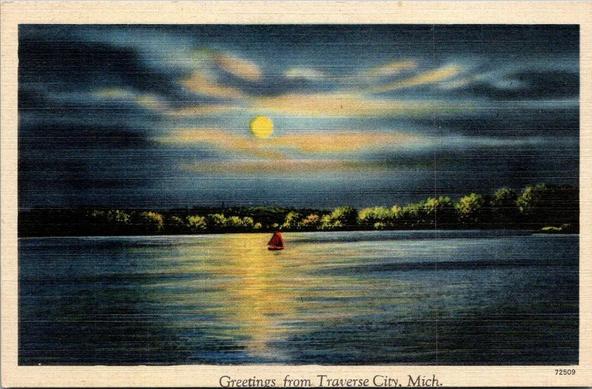 Moonlight over lake Michigan. You see a small red sailboat under the moons rays.