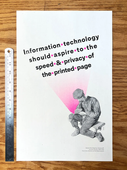 back cover of a white  booklet with the words: information technology should aspire to the speed and privacy of the printed page. A BW image of seated man reading a book, a pink cone of light radiates from the page