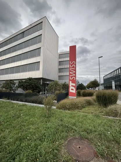 The DT Swiss building in Bienne with their logo on a red sign.