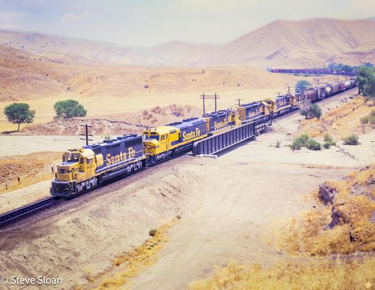 Only Santa Fe
On Friday, June 18, 1982. Atchison, Topeka and Santa Fe Railway (ATSF) 3821 led 5938, 4630, an SD40-2, 8050 and another C30-7 westbound at Ilmon, CA.