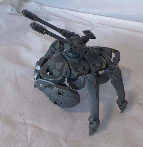 An insectile bug robot with a green sensor eye, claws, and twin guns on its back. Side view.