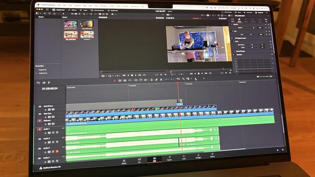 Laptop screen with DaVinci Resolve visible, a video edit in progress
