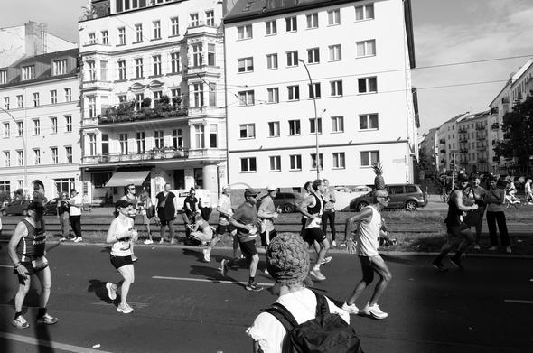 A man is seen running while balancing a pineapple on his head. That’s what he does - he runs an entire marathon with a pineapple balanced on his head.