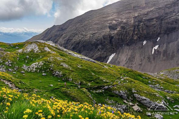 Woman hiking through a beautiful mountain landscape.