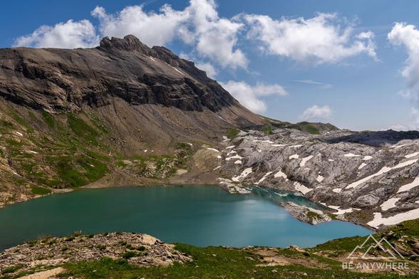 Mountain lake with impressive rock faces next to it.