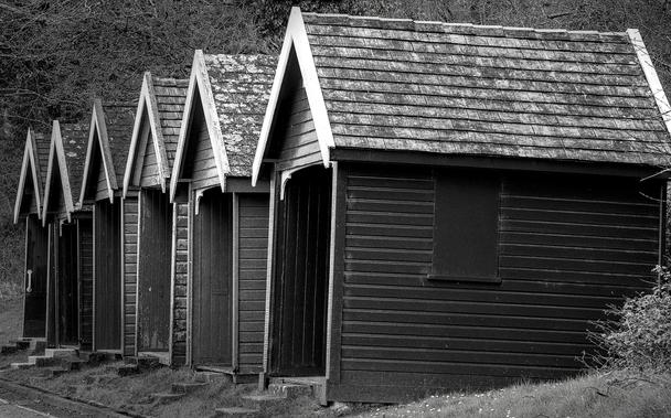 Old beach huts in black and white