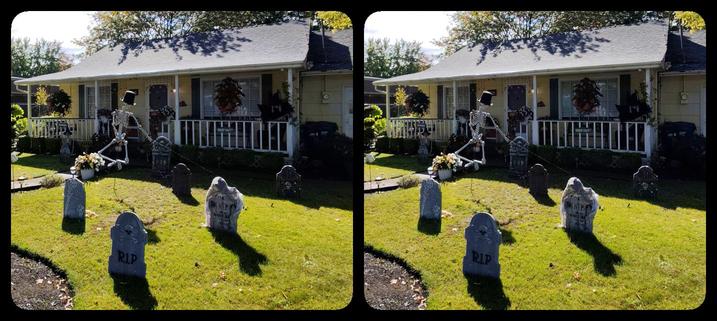 A Halloween yard display. In the middle is a skeleton in a top hat, leaping in the air like Fred Astaire.