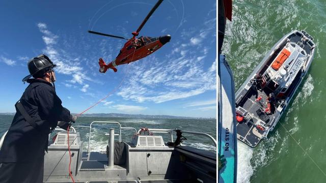 Alameda Post - an AFD firefighter stands on a boat and holds a rope connected to a red helicopter. The rope holds a metal basket.