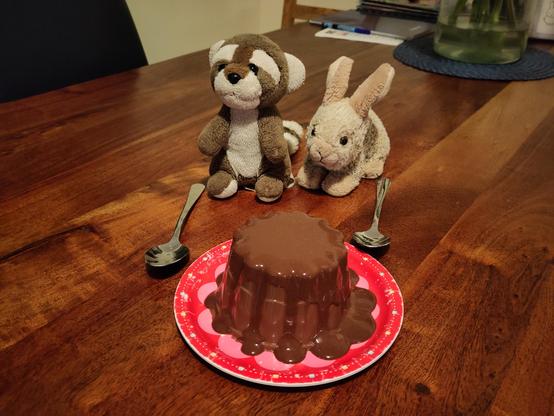 Bunbun and Sebas next to a ginormous chocolate pudding