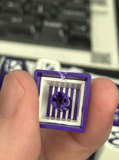 Closeup of the back of one of the double-shot caps, showing the injection molding process.