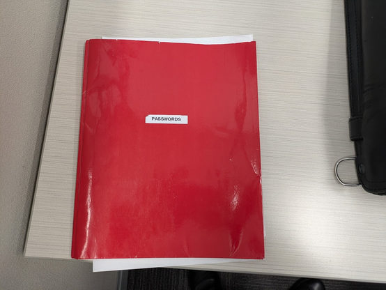 An image of a red file folder with a sticker labeled "PASSWORDS"