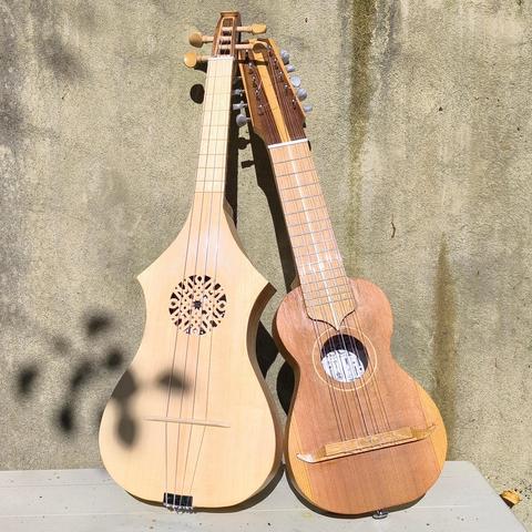 A citole and a charango I built, leaning against a wall together in the autumn sunshine.