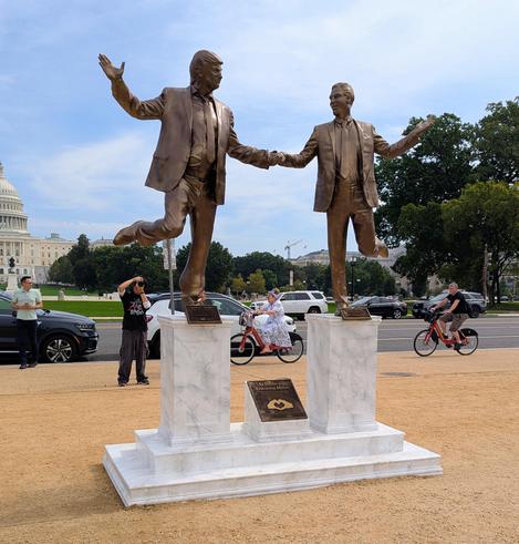 Photo of a statue depicting Donald Trump and Jeffrey Epstein holding hands and gazing at each other happily. This artwork was placed on the National Mall early Tuesday morning.