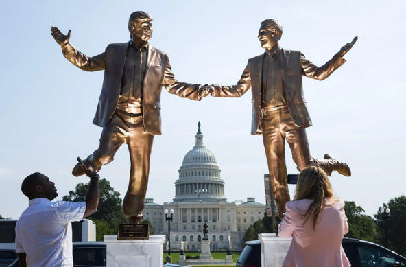 People stop to examine a statue featuring President Donald Trump and deceased financier Jeffrey Epstein outside the US Capitol.
Tom Brenner/For The Washington Post
