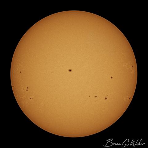 A full disk solar image taken with a monochrome camera and colorized orange
