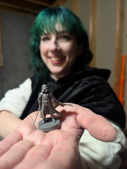 Bethany holding up Darth Vader from star wars legion