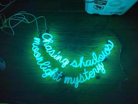 Chasing Shadows in the top line and moonlight mystery in the bottom line, placed on hardwood floors, white wires leading to the tubes and bucket above