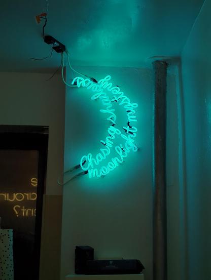 Chasing shadows moonlight mystery Rocks off neon seen in focus and zoomed in. A heat pipe is immediately to its right and shelf for fancy soaps is below it. Other neon on the opposing wall can be seen in the reflection of the window.